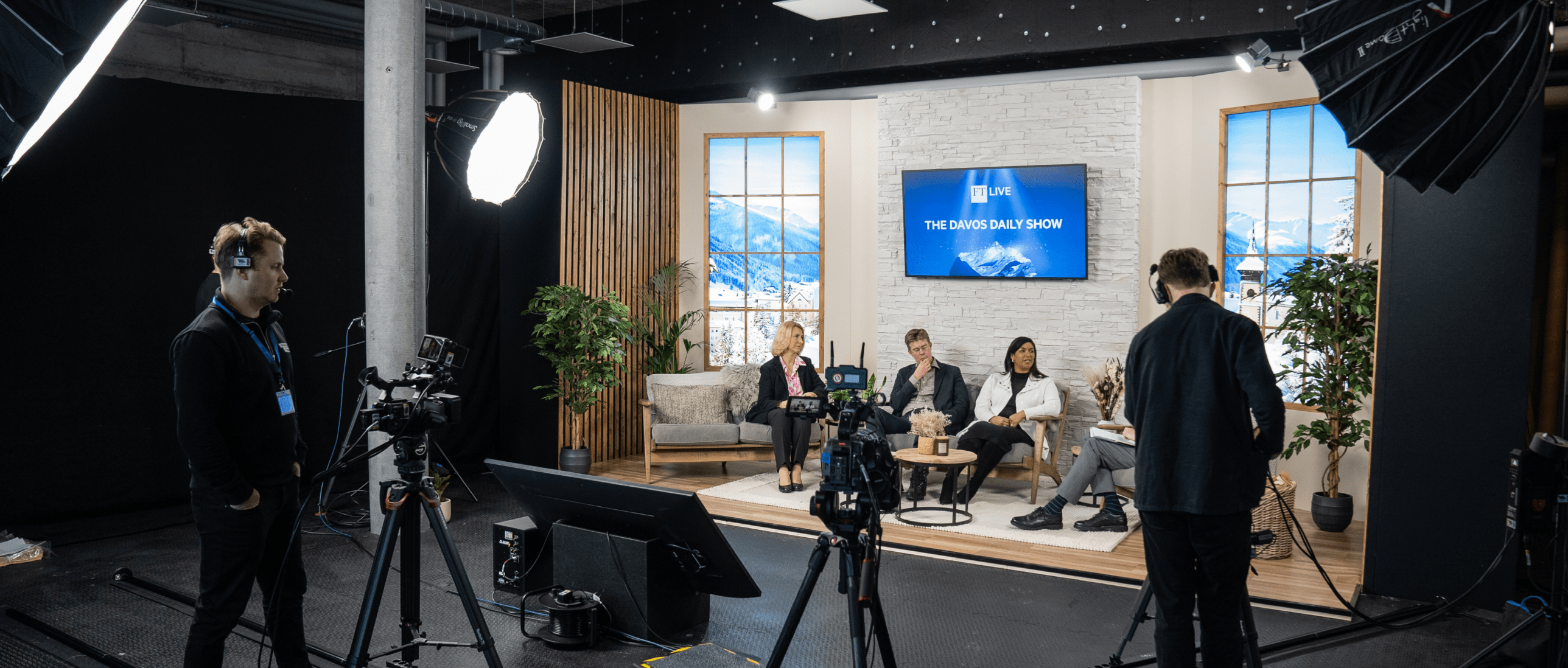 Event Production for The FT Live Studio in Davos. The LF team stand behind multiple camera setups to film an interview with FT live. The panel sit within the alpine inspired custom set design whilst being live streamed.