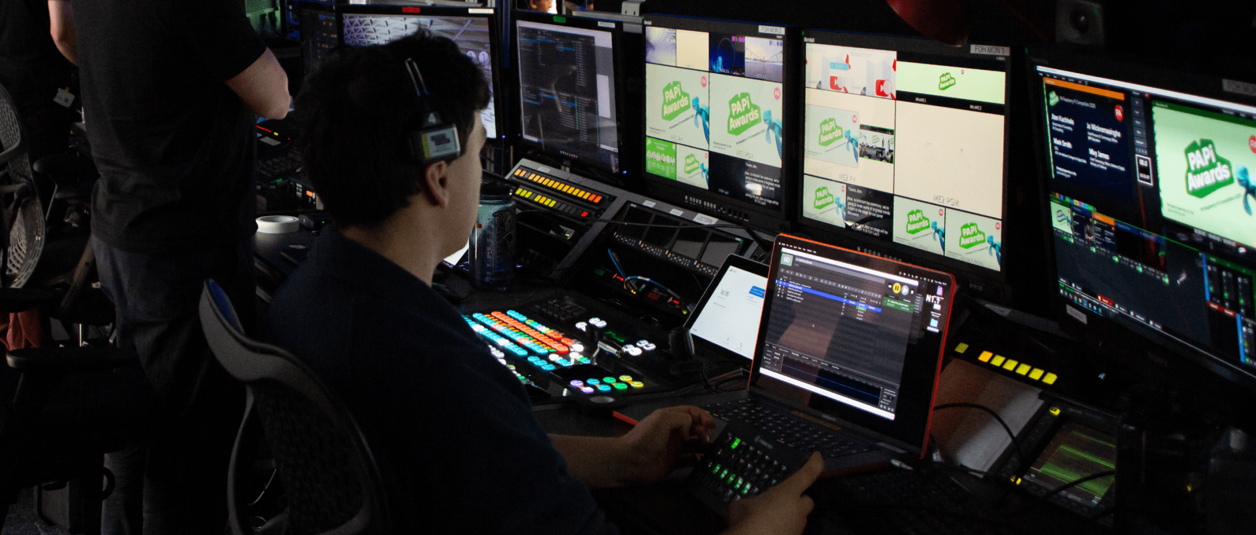 Live steam engineer working on a live event sitting in front of a panel of computer screens